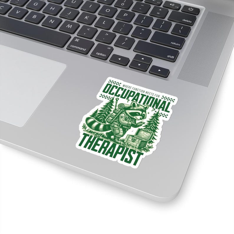 May include: Green and white sticker with a cartoon raccoon wearing a backpack and holding a magnifying glass. The text "Where function meets fun" is above the raccoon and the text "Occupational Therapist" is below the raccoon.