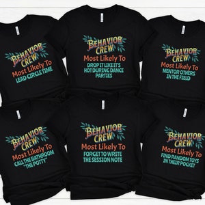 May include: Six black t-shirts with a colorful graphic design that says "Behavior Crew" and a funny phrase about the person wearing the shirt. The phrases are: "Most Likely To Lead Circle Time", "Most Likely To Drop It Like It's Hot During Dance Parties", "Most Likely To Mentor Others In The Field", "Most Likely To Call The Bathroom "The Potty"", "Most Likely To Forget To Write The Session Note", "Most Likely To Find Random Toys In Their Pocket".