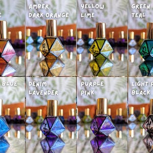 May include: An assortment of eight geometric-shaped perfume bottles in various colors, including red-orange, amber, yellow-lime, green-teal, bright blue, denim-lavender, purple-pink, and light pink-black. Each bottle has a gold cap and a mirrored base.