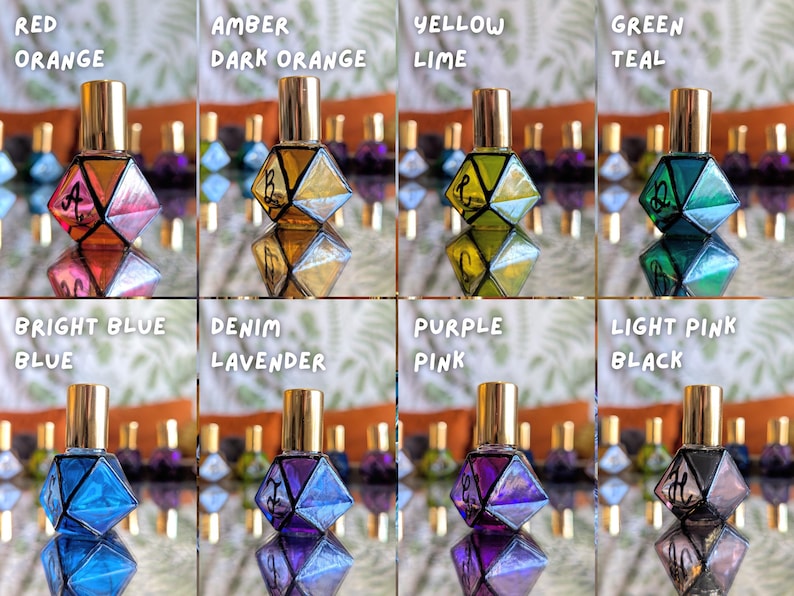 May include: An assortment of eight geometric-shaped perfume bottles in various colors, including red-orange, amber, yellow-lime, green-teal, bright blue, denim-lavender, purple-pink, and light pink-black. Each bottle has a gold cap and a mirrored base.