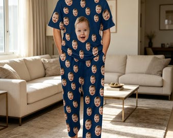 May include: A dark blue short-sleeved t-shirt and matching pajama pants set featuring a repeating pattern of a smiling baby's face. The center of the shirt displays a larger version of the same baby's face, creating a custom photo print design.