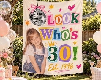 May include: A rectangular fabric banner featuring a photo of a young person in denim overalls, a disco ball graphic, and colorful text that reads Look Who's 30! Est. 1996. The design includes stars, a heart, and a crown icon on a cream background.