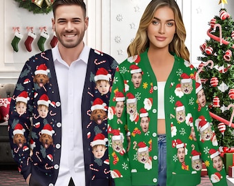 May include: Two people wearing Christmas-themed cardigans. One is navy blue with faces, Santa hats, and candy canes. The other is green with faces, Santa hats, and snowflakes. Both cardigans have a button-up front.