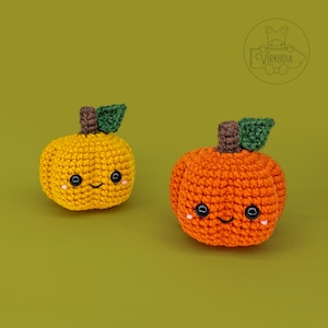 May include: Two crocheted pumpkins with smiling faces. One pumpkin is orange and the other is yellow.