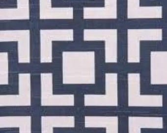 May include: A geometric pattern fabric with a white background and navy blue squares and rectangles.