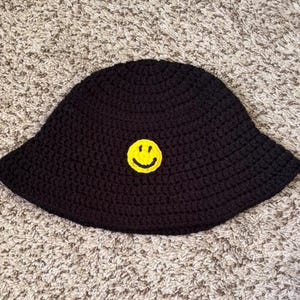 May include: A rustic wooden sign with the text "Welcome to our home" in white lettering. The sign features a distressed finish and a simple, inviting design, perfect for a front porch or entryway.