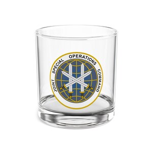 May include: A clear glass tumbler with the words "JOINT SPECIAL OPERATIONS COMMAND" in a circular design around a globe and crossed swords. The design is in blue, gold, and white.