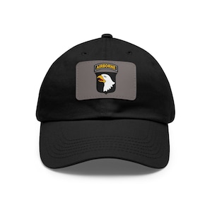 May include: Black baseball cap with a gray patch featuring a white eagle with a yellow beak and the text "AIRBORNE" in yellow.