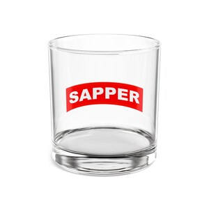 May include: A clear glass tumbler with the word "SAPPER" printed in white on a red curved banner.