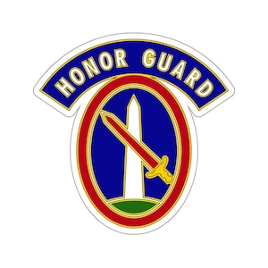 May include: A blue and red oval patch with a white obelisk and a red sword with a gold hilt. The patch has a white curved banner with the text "HONOR GUARD" in gold letters.