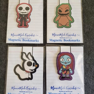 May include: Four magnetic bookmarks featuring characters from The Nightmare Before Christmas. Each bookmark is a different character, including Jack Skellington, Oogie Boogie, Zero, and Sally. The bookmarks are packaged on lined paper with the text "MamaMade Keepsakes" and "Magnetic Bookmarks".