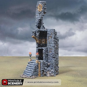 May include: A miniature stone tower ruin featuring grey masonry, a set of stairs leading to an entrance, and two small torches with orange flames. The structure includes a partial upper level and a tall, jagged spire. Text reads PRINTABLE SCENERY.