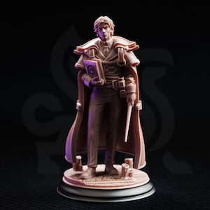 May include: A light brown resin miniature figurine of a person wearing a long coat, a collared shirt, and a tie. The figure holds a book in one hand and a thin wand in the other, standing on a circular base with small cylindrical details.