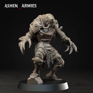 May include: A gray miniature figurine of a hulking armored creature with a helmet, tubing, and sharp claws on both hands. The figure stands on a circular base and features a chain detail hanging from the waist. The text ASHEN ARMIES is visible.