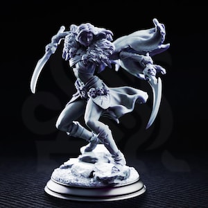 May include: A light purple miniature figurine of a warrior in a dynamic pose, holding two curved blades. The figure wears a fur-lined collar, skull-adorned belt, and a flowing cape, standing on a rocky base against a dark background.