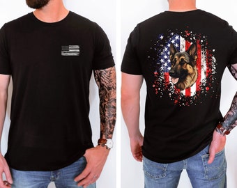 May include: Black t-shirt with a small American flag on the left chest and a German Shepherd dog head in front of a distressed American flag on the back.