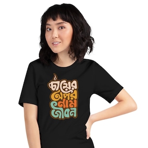 May include: Black t-shirt with a colorful graphic design featuring the text "চা ছাড়া জীবন নাই" in Bengali.