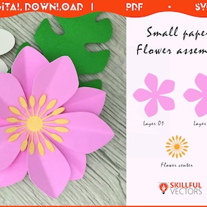 May include: A pink paper flower with yellow center, green leaf, and white paper cutouts. The image includes instructions for a small paper flower assembly, with the text "Small paper Flower assembly".