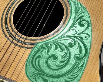 May include: Acoustic guitar with a green pickguard featuring an engraved floral design. The guitar has a natural wood finish, black strings, and a soundhole. The pickguard is shaped to fit the guitar's body. The text "DUST STORM ENGRAVING" is visible.
