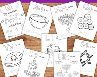May include: A collection of black and white Hanukkah-themed coloring pages. The pages feature illustrations of applesauce, menorahs, gelt, a Star of David, and other holiday symbols. The text "Hanukkah A-Z Coloring Book" is at the top.