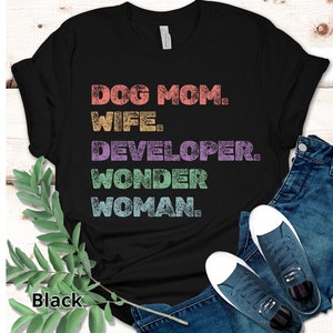 May include: Black t-shirt with a distressed graphic that reads "Dog Mom. Wife. Developer. Wonder Woman."