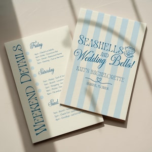 May include: Two-page bachelorette party itinerary with a light blue and white striped design. The cover reads "Seashells and Wedding Bells!" with the name "Kait's Bachelorette" and the location "Seaside, Florida". The left page lists weekend details.
