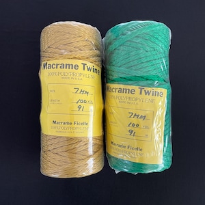 May include: Two spools of macrame twine, one yellow and one green. Both spools are labeled "Macrame Twine" and "Macrame Ficelle". The yellow spool is 7mm thick and 100 yards long. The green spool is 7mm thick and 100 yards long.