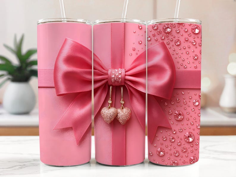 Pu&ograve; includere: Tre bicchieri in acciaio inossidabile rosa con un fiocco rosa e ciondoli a forma di cuore dorati. I bicchieri hanno design diversi, uno con un fiocco rosa, uno con un fiocco rosa e cuori dorati e uno con un design glitter rosa.