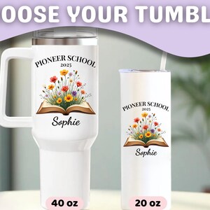 May include: White tumblers with floral designs and the text "Pioneer School 2025" and the name "Sophie". One tumbler has a handle and holds 40 oz, the other holds 20 oz. The tumblers have a lid and a straw.