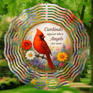 May include: A metal wind spinner with a colorful floral design and a cardinal bird. The spinner has the text "Cardinals appear when Angels are near".