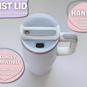 May include: White insulated mug with a gray twist lid and handle. The mug is Stanley compatible and features a comfy grip handle. Text on the image reads "TWIST LID" and "HANDLE".