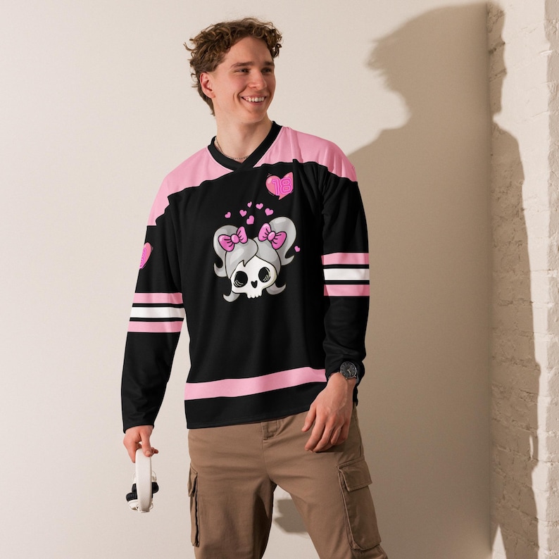 Model wearing Lil Miss Mosh Pit cute pink and black jersey with skull and pink bow ties. Hockey long sleeve rave jersey for girls and edm lovers. Made of Recycled materials and made to order for sustainability!