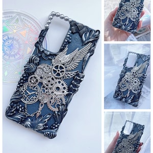 May include: A black phone case with a silver, steampunk-inspired design. The case features gears, wings, and a clock face.