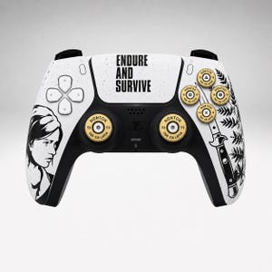 May include: A white and black game controller featuring the text ENDURE AND SURVIVE, a portrait of a person, a knife illustration, fern leaf graphics, and gold-coloured analogue sticks and action buttons designed to resemble ammunition casings.