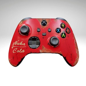 May include: Red Xbox controller with a distressed, rusty look. The controller has a Nuka Cola logo on the front.