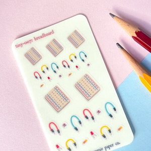 May include: A sheet of clear stickers with illustrations of breadboards and jumper wires. The stickers are labelled "tiny-007: breadboard" and "annie paper co."
