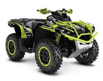 May include: A black and green Can-Am Outlander 650 ATV with black wheels and green rims. The ATV has a black and green graphic design with the words "Can-Am" and "Outlander" on the side.