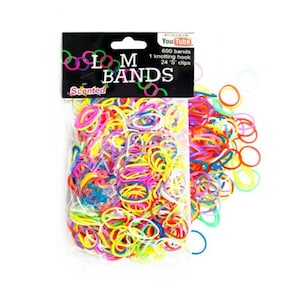 May include: A clear plastic bag filled with colorful rubber bands. The bag has a label that says "LM Bands" and "Scented". The label also says "600 bands, 1 knotting hook, 24 'S' clips".
