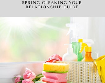 May include: A white wicker basket filled with cleaning supplies, including a green spray bottle, a yellow spray bottle, and a white bottle. There are also colorful sponges stacked on a white surface next to the basket. A bouquet of pink tulips is in the foreground.