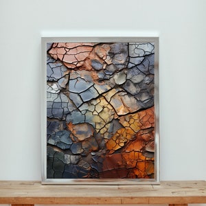 Puede incluir: Impresión de arte abstracto con una superficie texturizada y agrietada en tonos de azul, marrón y naranja. La impresión está enmarcada en un marco plateado.