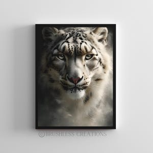May include: A framed print featuring a close-up of a snow leopard's face. The animal has white fur with black spots and piercing green eyes. The print is in a black frame and the text "BRUSHLESS CREATIONS" is at the bottom.