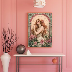 May include: A digital art print featuring a woman with long red hair standing in a garden with pink flowers. The woman is wearing a white dress and has a flower in her hair. The print is framed in a wooden frame.