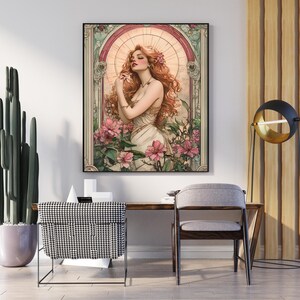 May include: A painting of a woman with long red hair standing in a garden with pink flowers. The woman is wearing a white dress and has a flower in her hair. The painting is framed in a gold frame.