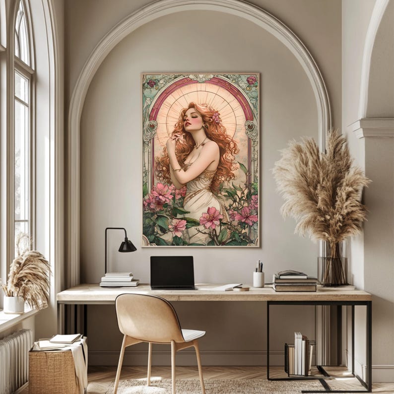 May include: A digital art print featuring a woman with long red hair standing in a field of pink flowers. The woman is wearing a white dress and has a halo of light around her head. The print is framed in a decorative border.