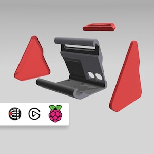 Puede incluir: Una carcasa de ordenador Raspberry Pi impresa en 3D desmontada. La carcasa es de plástico negro y tiene un acento rojo. La carcasa está diseñada para ser utilizada con un Raspberry Pi 4.