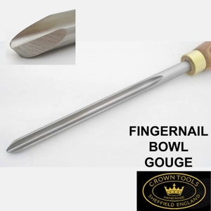 May include: A close-up of a fingernail bowl gouge, a woodworking tool with a long, thin blade and a rounded tip. The tool is made of metal and has a wooden handle. The blade is sharpened to a fine point. The tool is labelled "FINGERNAIL BOWL GOUGE" and "CROWN TOOLS HANDMADE SHEFFIELD ENGLAND".