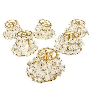 May include: Six vintage crystal chandelier shades with gold-toned metal frames. The shades are covered in clear, faceted crystals, creating a sparkling effect. The shades are designed to diffuse light and add a touch of elegance to any room.