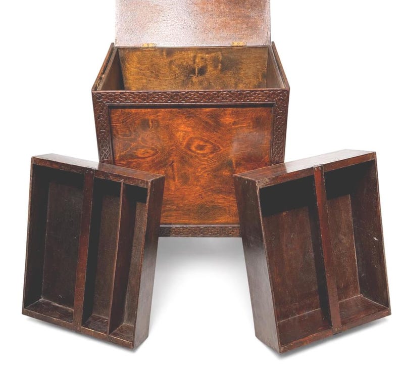 May include: A wooden chest with an open lid and two removable trays. The chest and trays are a rich, dark brown color, with visible wood grain. The chest has a decorative border around the top.