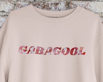 May include: A light pink sweatshirt with the word "GABAGOOL" printed in red and white on the front.
