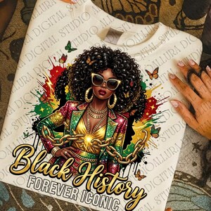 May include: A white sweatshirt featuring a vibrant illustration of a woman with curly hair, sunglasses, and gold jewelry. The design includes the text "Black History Forever Iconic" with butterflies and colorful accents.